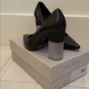 Black block heel pumps with acrylic heels.